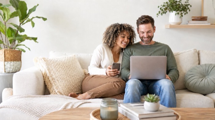 Couple reviewing loan options together on a laptop