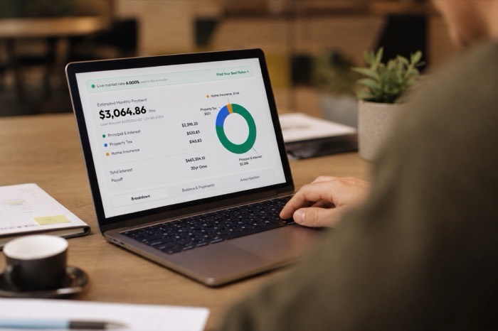 Laptop showing a mortgage payment breakdown and chart